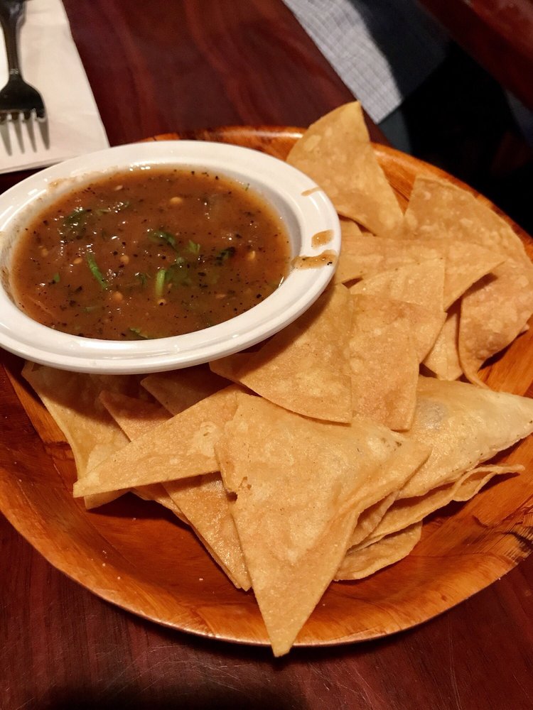 Tortilla chips and a bowl of red salsa